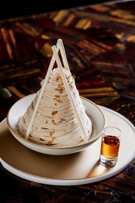 A dome of shaved ice is dusted with green tea powder and layered with homemade organic red bean paste.
