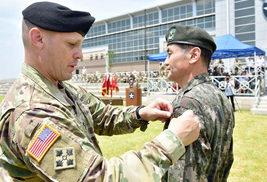14 THE INDIANHEAD Maj. Gen. D. Scott McKean, commanding general, 2nd Infantry Division ROK-U.S Combined Division places the combined division patch on Brig. Gen. Kim, Yong Chul, the incoming deputy commanding general for ROK at the Deputy Commanding General Patch Ceremony on the 2nd Infantry Division Parade Field June 15.