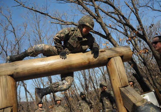 6 THE INDIANHEAD (Bottom Left) Cadet Lim Hamin wills himself over an obstacle with his cadet teammate s encouragement.
