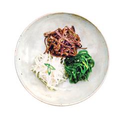 samsaek namul [ 삼색나물 ] E Bellflower roots, spinach, and fiddlehead namul served on a plate.