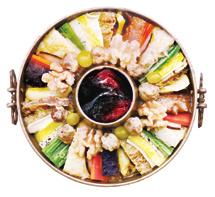 sinseollo [ 신선로 ] E A hot pot of seafood, meat, and vegetables cooked at the table in a brass sinseollo pot over hot