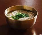 The thoroughly boiled broth is poured over steamed white rice and thin pork slices daintily set in a large brass